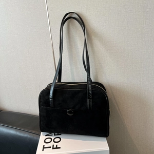 Black suede hobo bag for women featuring a large buckle front pocket and top zipper closure