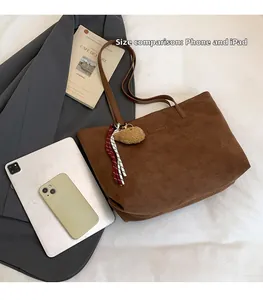 Deep brown suede tote bag size comparison with tablet and phone for daily commute