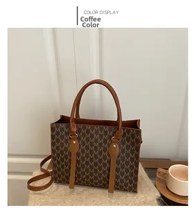 Detailed coffee tote bag showing M-pattern print, round handles and detachable strap