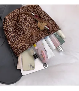 Macro shot of large leopard print tote bag interior showing ample storage space