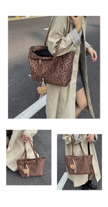 Detailed close-up of leopard print tote bag with brown handles and a cute bear charm