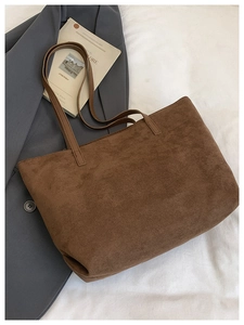 Detailed texture view of dark brown corduroy tote bag with sleek faux leather straps