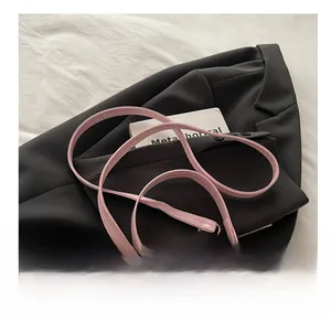 Gros plan du sac bandoulière rose à effet croco avec boucle en métal doré CD et lanière