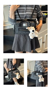 Close-up of grey polka dot canvas Boston bag with leather trim and bear charm