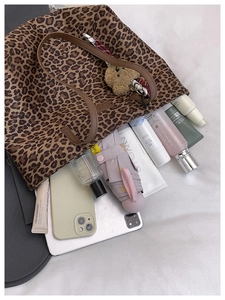 Spacious leopard print tote bag interior showing phone, cosmetics, and umbrella storage