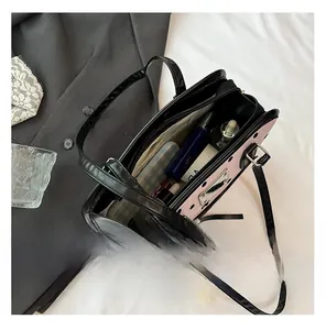 Spacious interior of black polka dot bag with compartments for cosmetics and essentials