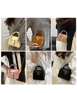 Detail showing various colors of mini boston bags with metal chain straps on models