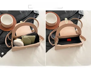 Detail of minimalist beige handbag interior showing capacity for phone and makeup items
