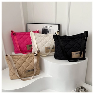 Sacs cabas en nylon matelassé aux couleurs vives présentés sur des marches géométriques chic