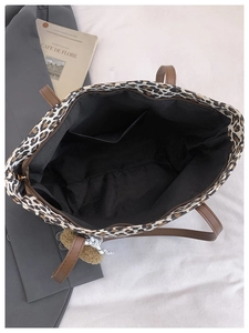 Top view of leopard print tote bag showing interior lining, inner pocket and zip closure