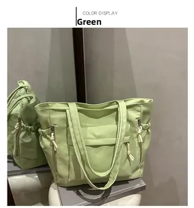Detail of light green tote bag with side drawstring pockets and front flap compartment