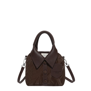 Brown shirt-style leather handbag with retro textures and button details shown in center