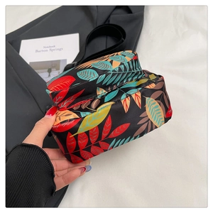 Detail of colorful leaf print nylon storage bag with secure zipper closure
