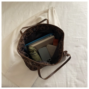Spacious leopard print tote bag showing interior storage for umbrella and tablet