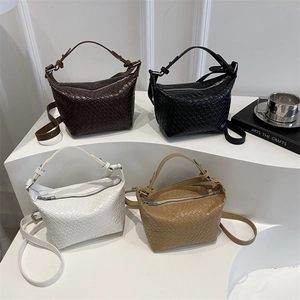 Chic woven leather handbags in four colors shown on display for autumn fashion style