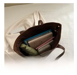 Internal view of large brown tote bag showing capacity for tablet, wallet, and essentials