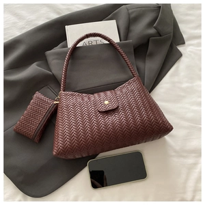 Detail of dark reddish-brown woven tote bag set with matching small zipper pouch