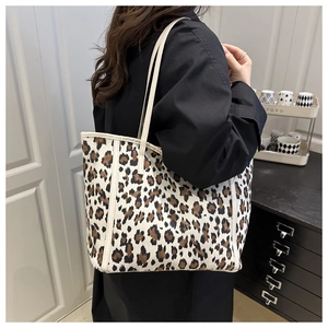 Leopard print tote bag showing the large capacity and canvas texture on a model shoulder