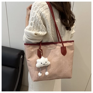Large taupe tote bag detail with wine red handles and a cute plush cloud charm