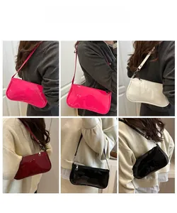 Glossy patent leather baguette bags shown in four colors on models for styling
