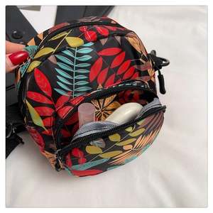 Detail view of mini printed canvas crossbody bag showing inner storage for cosmetics