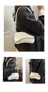 Detail showing white wavy flap shoulder bag with textured leather and knotted strap design