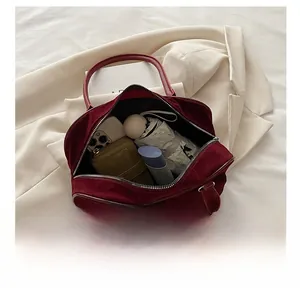 Detail showing the large interior capacity of this dark red suede Boston handbag
