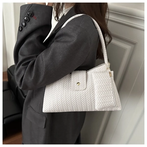 Detail of white woven tote bag featuring a metallic buckle and detachable mini coin purse