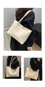 Detail of minimalist cream suede tote bag with double shoulder straps and logo plate