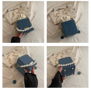 Detail of leopard print bucket bag with pearl handle, gold chain and protective base studs