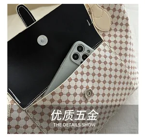 Detail of floral tote bag showing magnetic silver buckle and spacious inner phone pocket