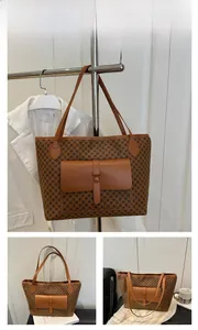Detailed view of brown tote bag with classic monogram print and front leather pocket