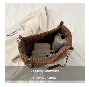 Detailed internal view of corduroy tote bag showing capacity for umbrella and phone