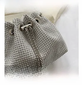 Macro shot of silver rhinestone drawstring bucket bag with sparkling chain detail