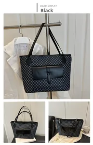 Detail view of large tote bag with geometric patterns and leather snap pocket