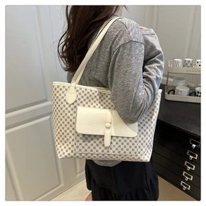Classic patterned tote bag shown on model highlighting large capacity and shoulder strap style
