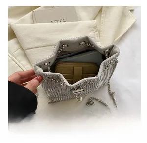 Internal storage view of silver rhinestone bucket bag showing space for a long wallet