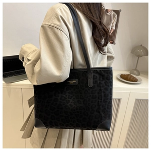 Detail of grey leopard print tote bag with reinforced leather corners and shoulder straps