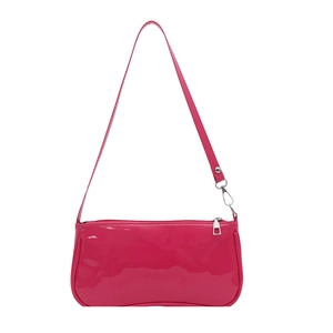 Pink glossy patent leather baguette shoulder bag with silver metal hardware on white background