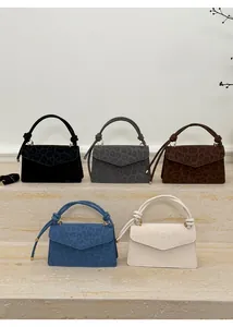 Detailed display of five stylish leopard print handbags in various colors with knotted handles
