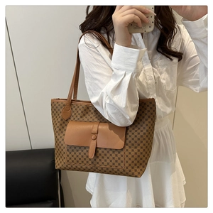 Detail of classic vintage printed tote bag with front pocket shown on a model