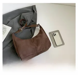Brown suede hobo bag shown next to a smartphone to demonstrate actual size and dimensions