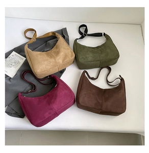 Detailed macro view of minimalist faux suede tote bags in multiple autumnal colors