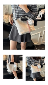 Detail of white woven texture tote bag with a cute plush puppy charm and shoulder strap
