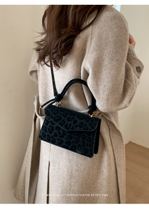 Minimalist leopard print crossbody bag styled with a wool coat in a chic retro look