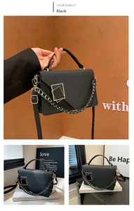 Detail of black crossbody bag featuring matte leather texture and golden metal square buckle