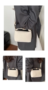 Detail of off-white leopard embossed leather handbag with gold lock and shoulder strap