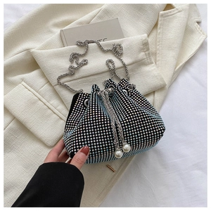 Detail of gradient crystal bucket bag featuring sparkling rhinestones and pearl drawstrings