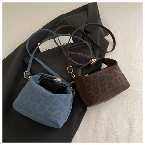Vue détaillée des sacs à main à imprimé léopard en bleu et marron avec boucles dorées