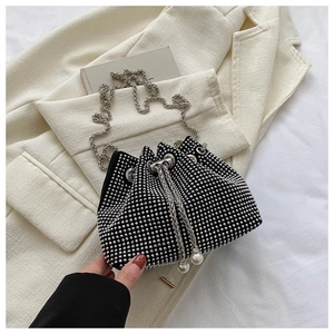 Macro shot of black bucket bag featuring sparkling silver rhinestones and pearl drawstring